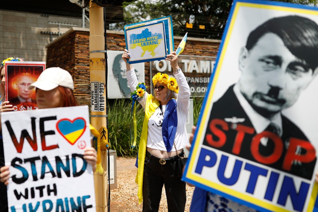 Supporters of the Ukrainian Association of South Africa wave anti-war posters to motorists passing through Pretoria as they protest in support of Ukraine.