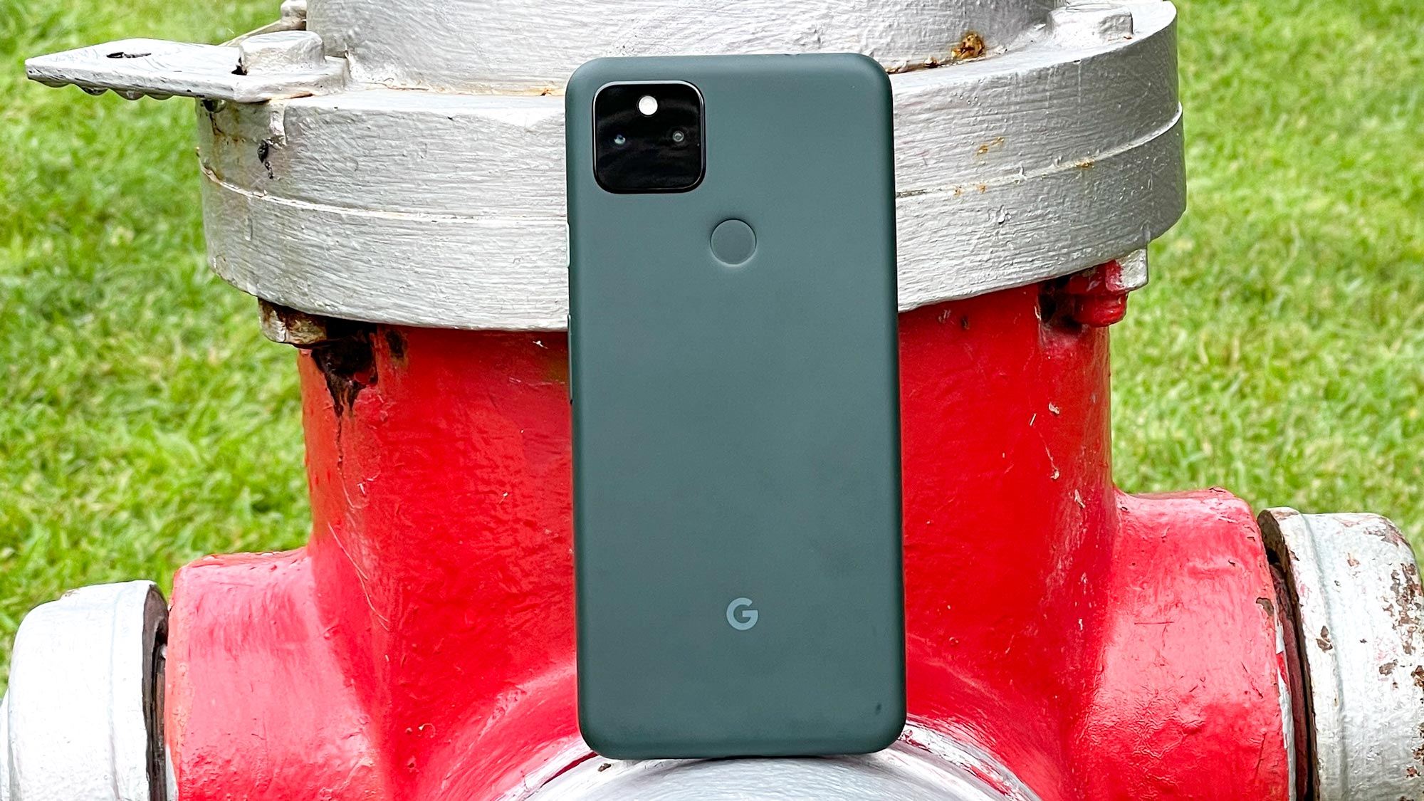 Google Pixel 5a resting on a metal tube