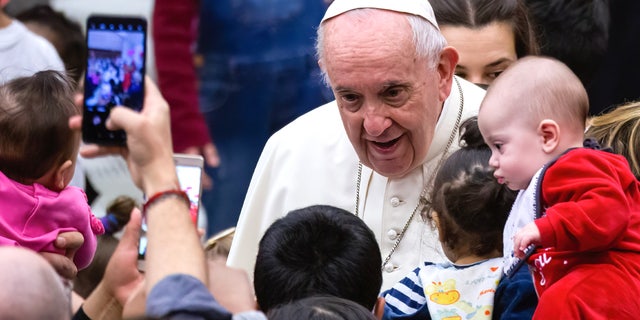 Pope Francis welcomes and blesses children with the help of the Santa Marta Pediatric Infirmary in the Vatican in the Paul VI Hall.