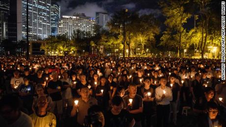People hold candles during a vigil in Hong Kong on June 4, 2018.