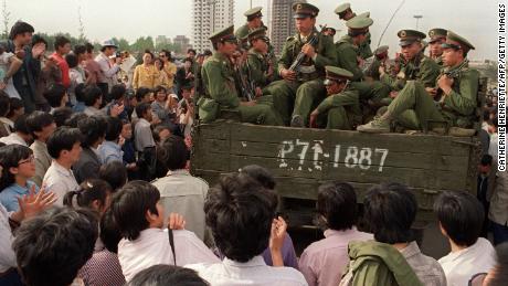 Pro-democracy protesters block a truck full of Chinese soldiers on their way to Tiananmen Square, May 20, 1989. 