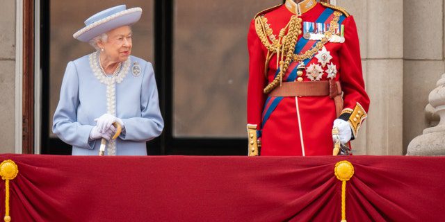 Queen Elizabeth and Prince Edward, Duke of Kent, watch the Queen's birthday parade from Buckingham Palace.