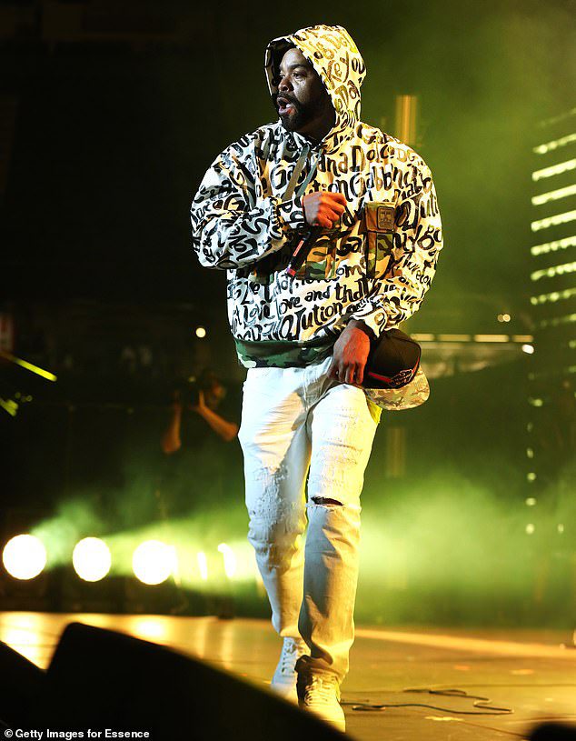 Complicated: the style wears a white hoodie covered in black text during a solo spot on stage