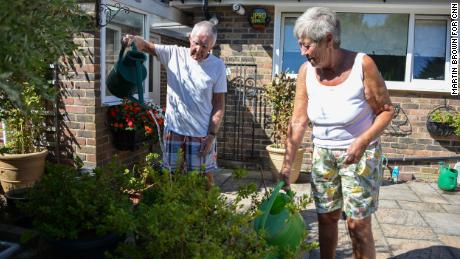 David and Margaret Miller watering their plants in their home in Edinbridge.