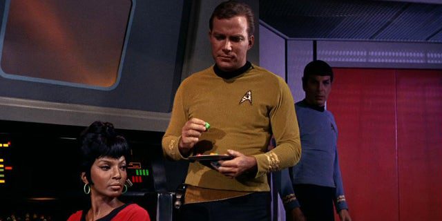 Nichelle Nichols (left, as Uhura) and William Shatner (as Captain James T. Kirk) on the USS Enterprise bridge in a scene from "man trap" The first episode of "star trek," which was broadcast on September 8, 1966.