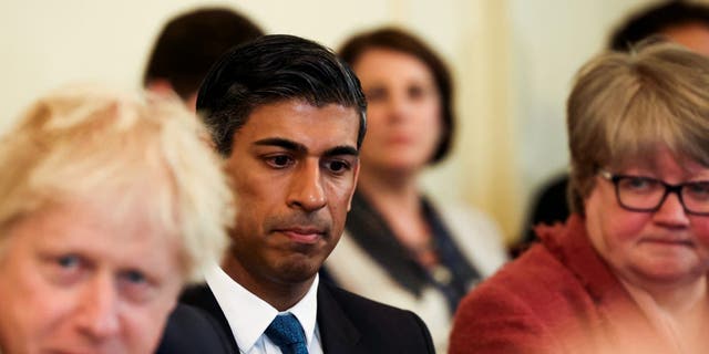 British Chancellor of the Exchequer Rishi Sunak, center, listens as Prime Minister Boris Johnson speaks at the weekly Cabinet meeting in Downing Street on May 17, 2022 in London. 