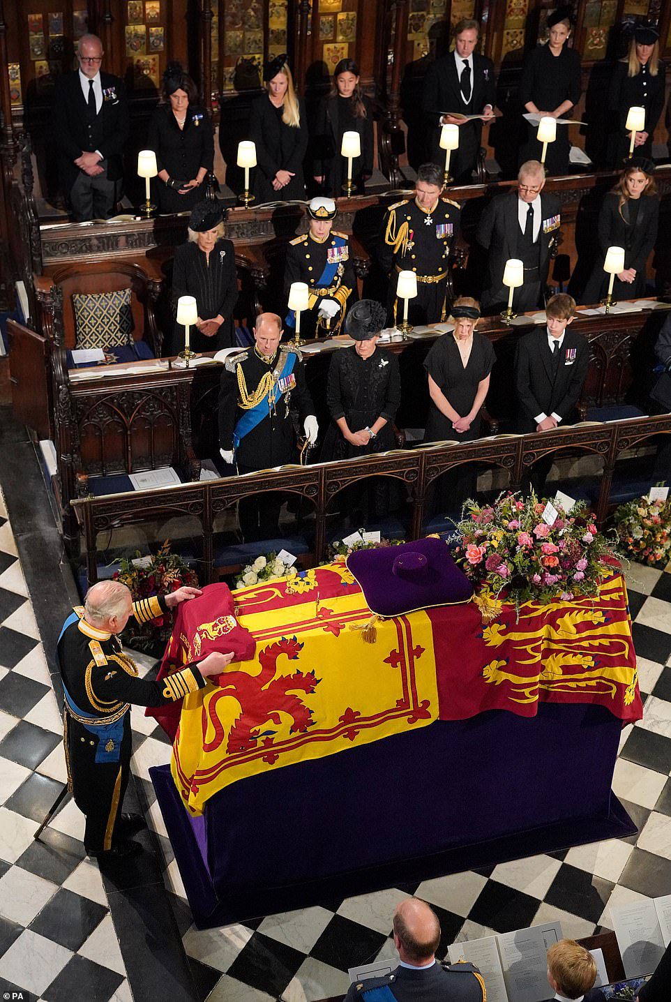 King Charles III lays the color of the Queen's Company's camp of the Grenadier Guards on Her Majesty's coffin at Monday's commissioning ceremony