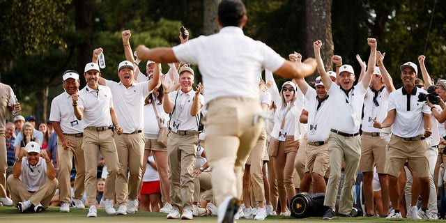 The international team cheers as Tom Kim of South Korea and the international team celebrate his big shot to win the first game with teammate Se Woo Kim of South Korea against Patrick Cantlay and Xander Shaveli on September 24, 2022 in Charlotte, North.  Carolina.