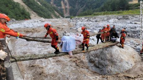 Rescue workers carry the wounded in Luoding County, Ganzi County, Sichuan Province, China, September 5, 2022.
