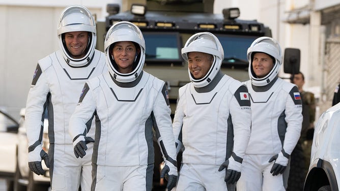 NASA astronauts Josh Cassada, left, and Nicole Mann, second from left, JAXA astronauts, JAXA astronauts, second from right, and Roscosmos astronaut Anna Kekina, right, wearing suits SpaceX, seen as they prepare to leave the ship.  Neil A's operations.