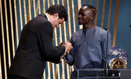 Sadio Mane receives the Socrates Award from the brother of the late Brazilian Ray.