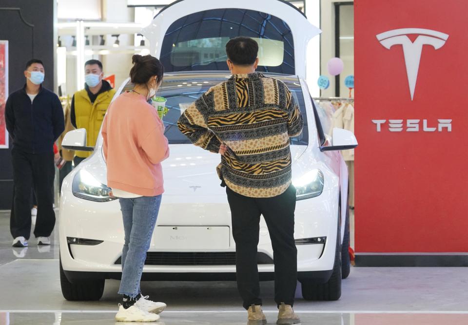 YANTAI, China - October 29, 2022 - Customers familiarize themselves with the Tesla Model Y at a mall in Yantai, Shandong Province, China, October 29, 2022. On October 24, 2022, Tesla China announced that it will reduce prices for its domestic Model 3 and Model Y, which are two are common.  (Photo credit must read CFOTO/Future Publishing via Getty Images)
